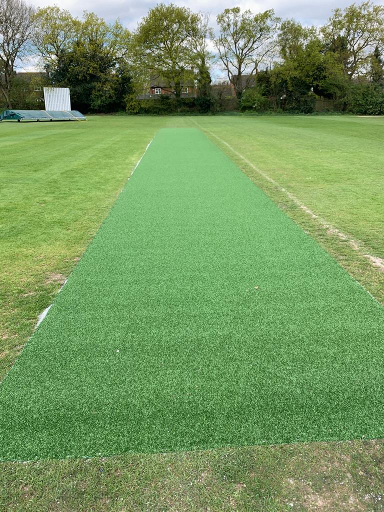 Image shows a new green non-turf cricket pitch just after installations